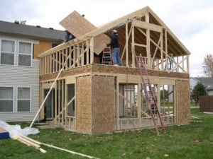 Here's an alt tag for the image: House addition under construction.