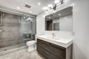 Modern bathroom with glass shower and vanity.